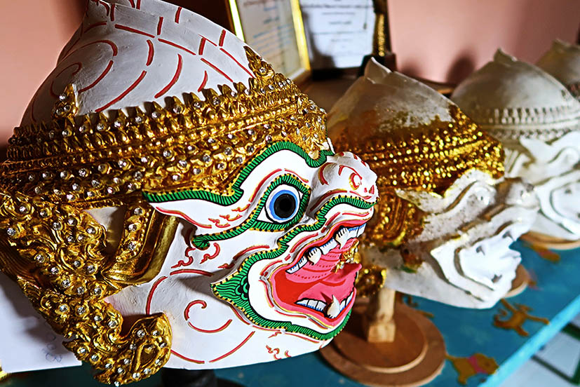 A mask of a monkey character in the Thai Khon dance, characterised by its open mouth with bared fangs.