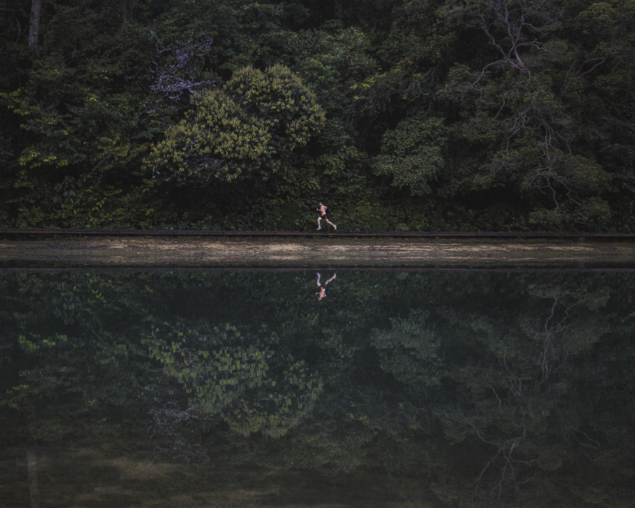 man running by a lake