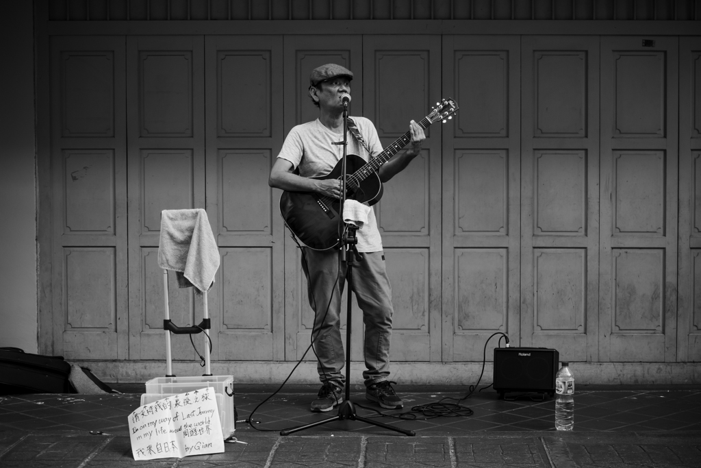 guitar player on the streets black and white