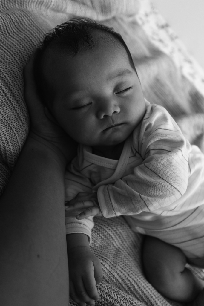 arm holding baby's head