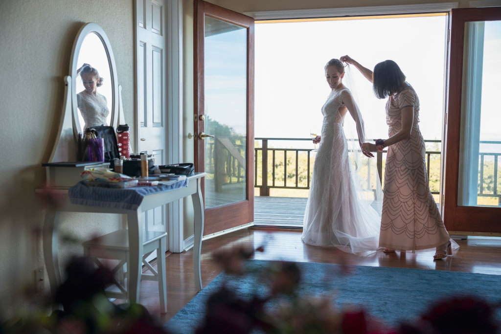 Bride and mother getting ready before wedding