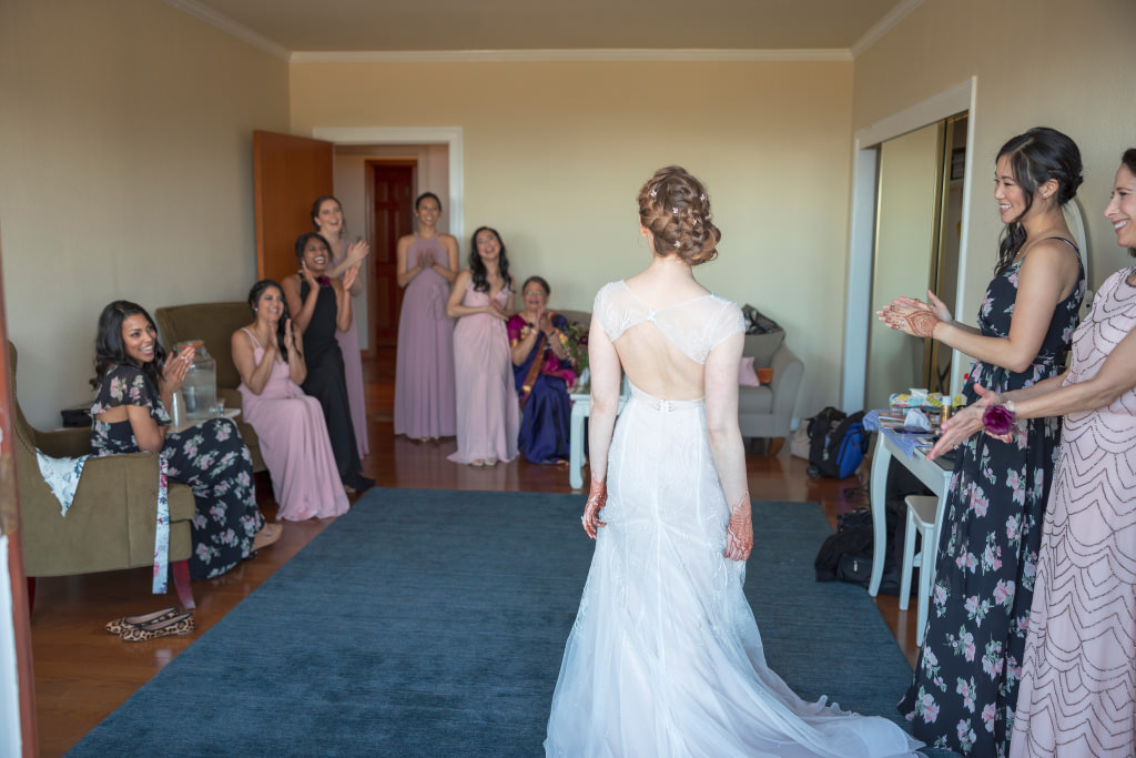 Bride in gown with mother-in-law watching