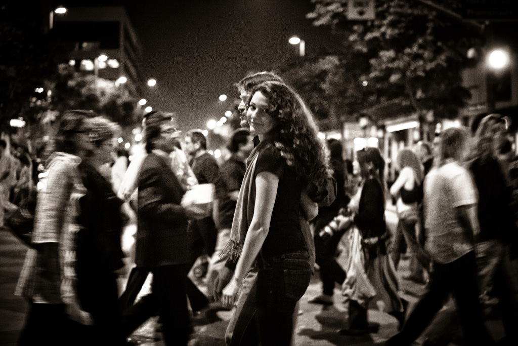 Black and white shot of couple in crowd