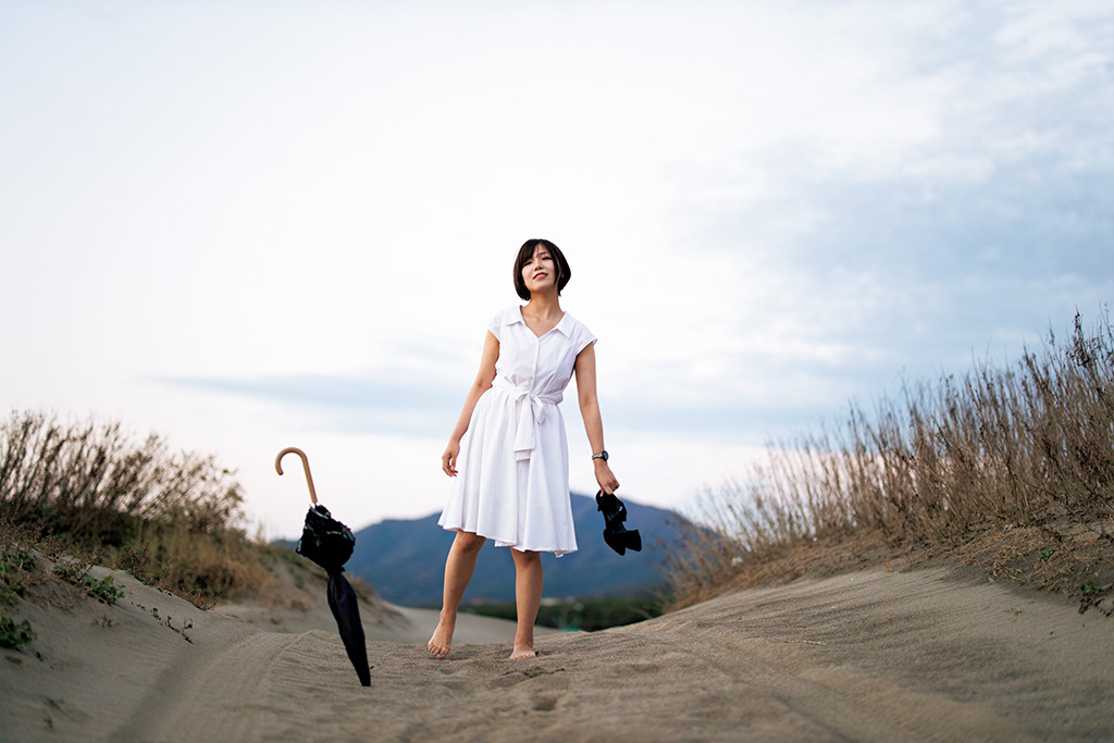 Barefoot girl in front of mountain