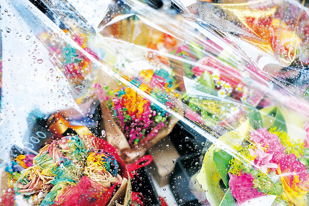 Bouquets under plastic cover in the rain